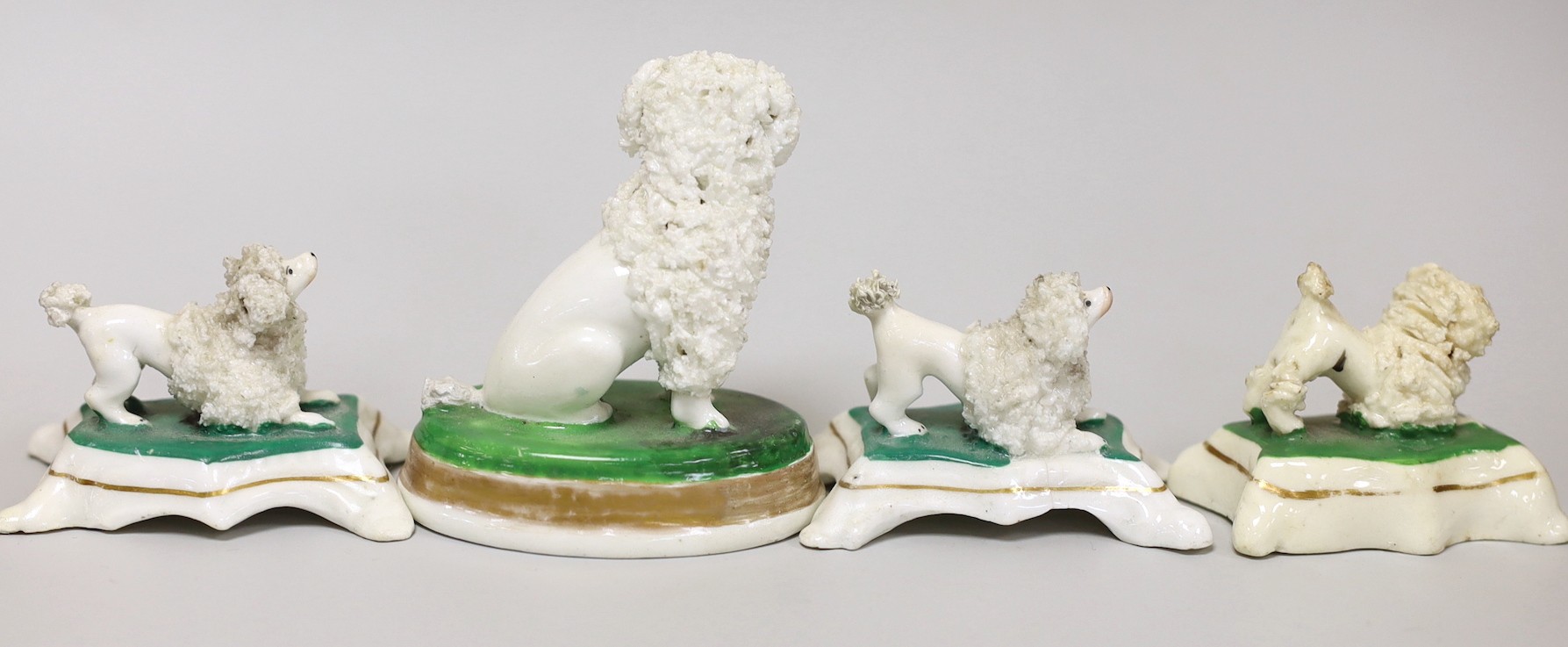 Four small Staffordshire models of poodles, c.1830-50, tallest 7cms high, Provenance Dennis G.Rice collection